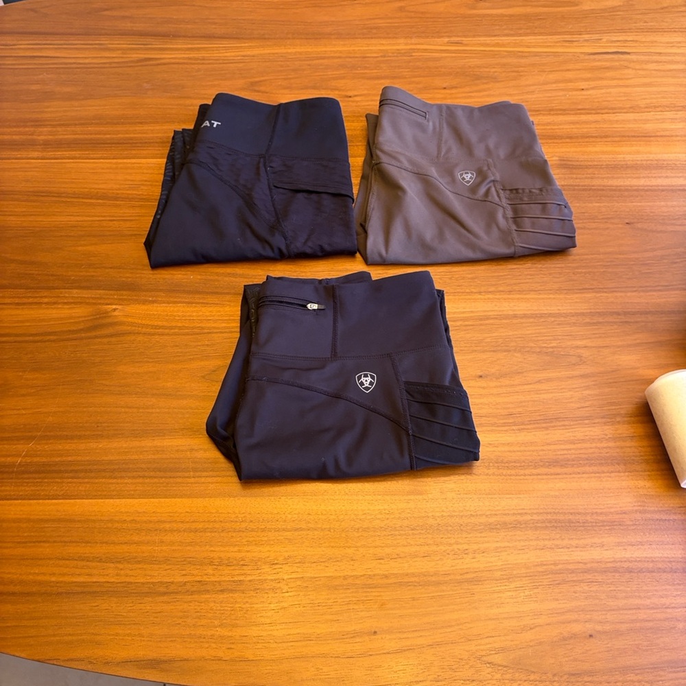 3 pairs of Ariat riding tights - 2 black, 1 khaki. Size large.